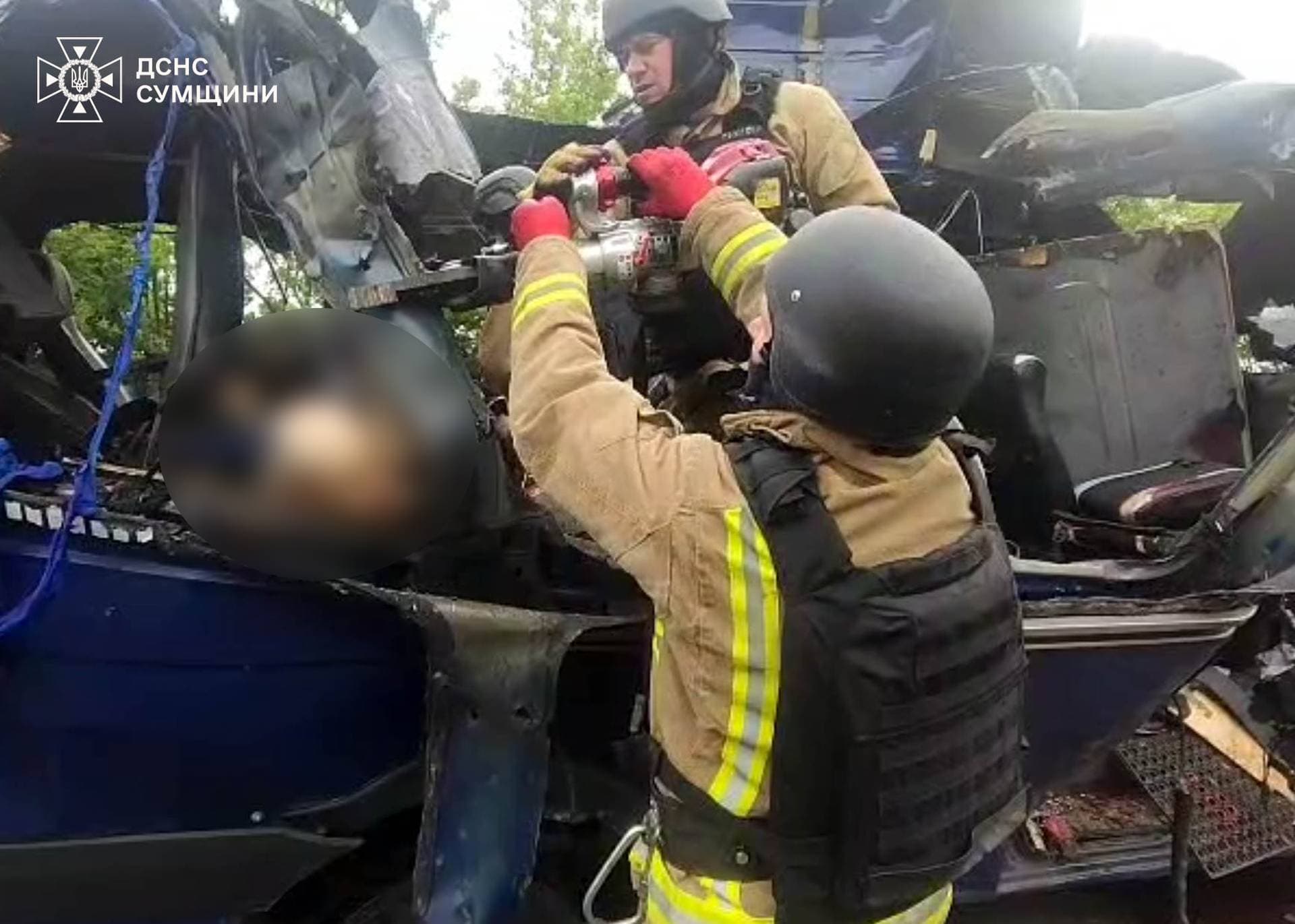 Emergency officers carry out rescue operations after a Russian strike on a van in Bilopillia in Sumy region