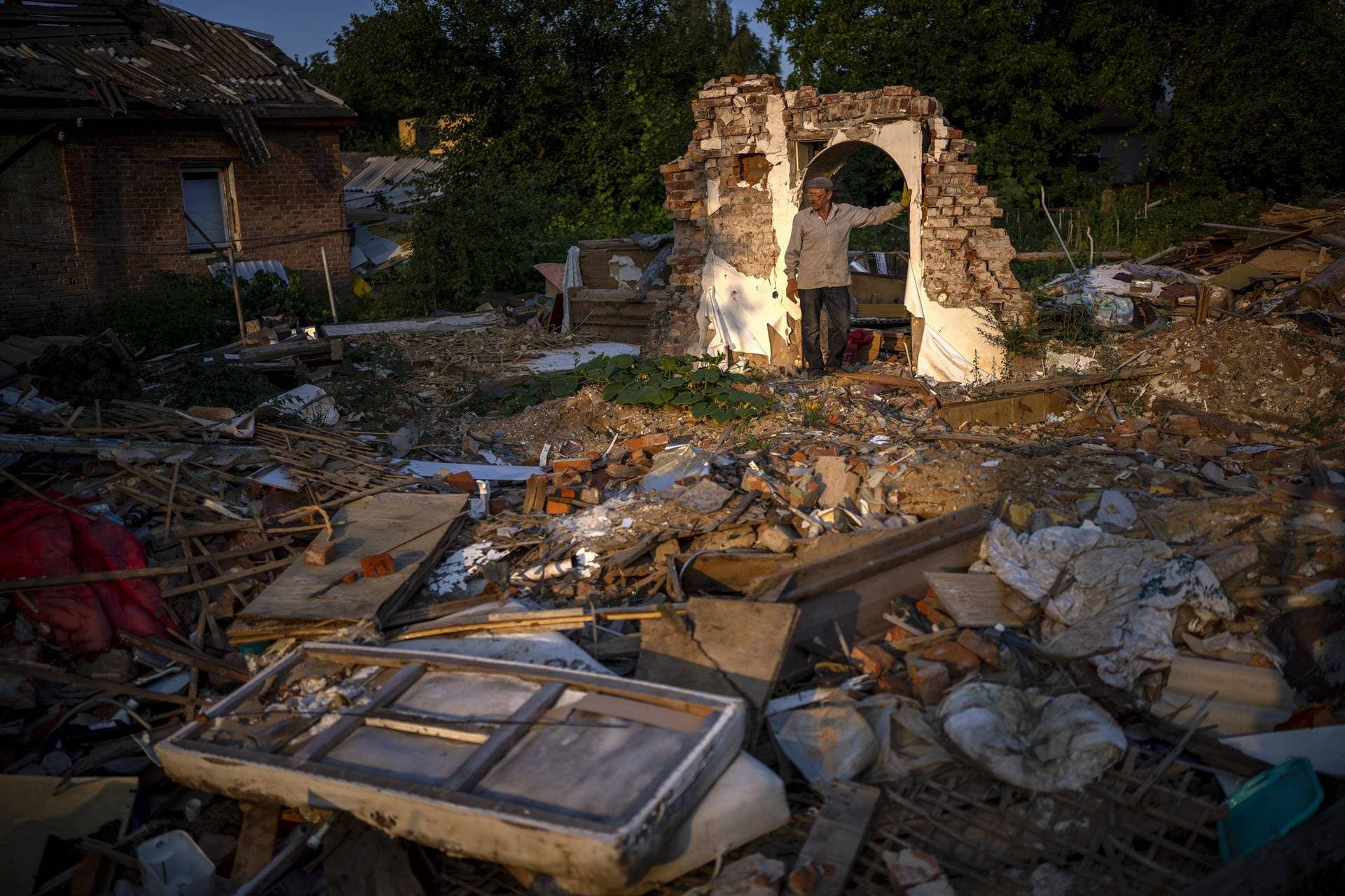 Vladimir stands next to the wreckage of his house after being bombed by Russians in Chernihiv