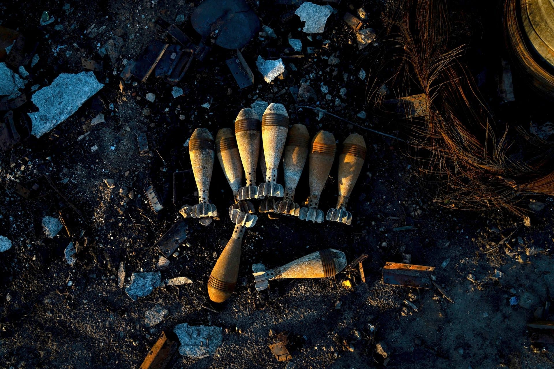 Burned mortar shells lie on the ground in the recently retaken area of Kamyanka