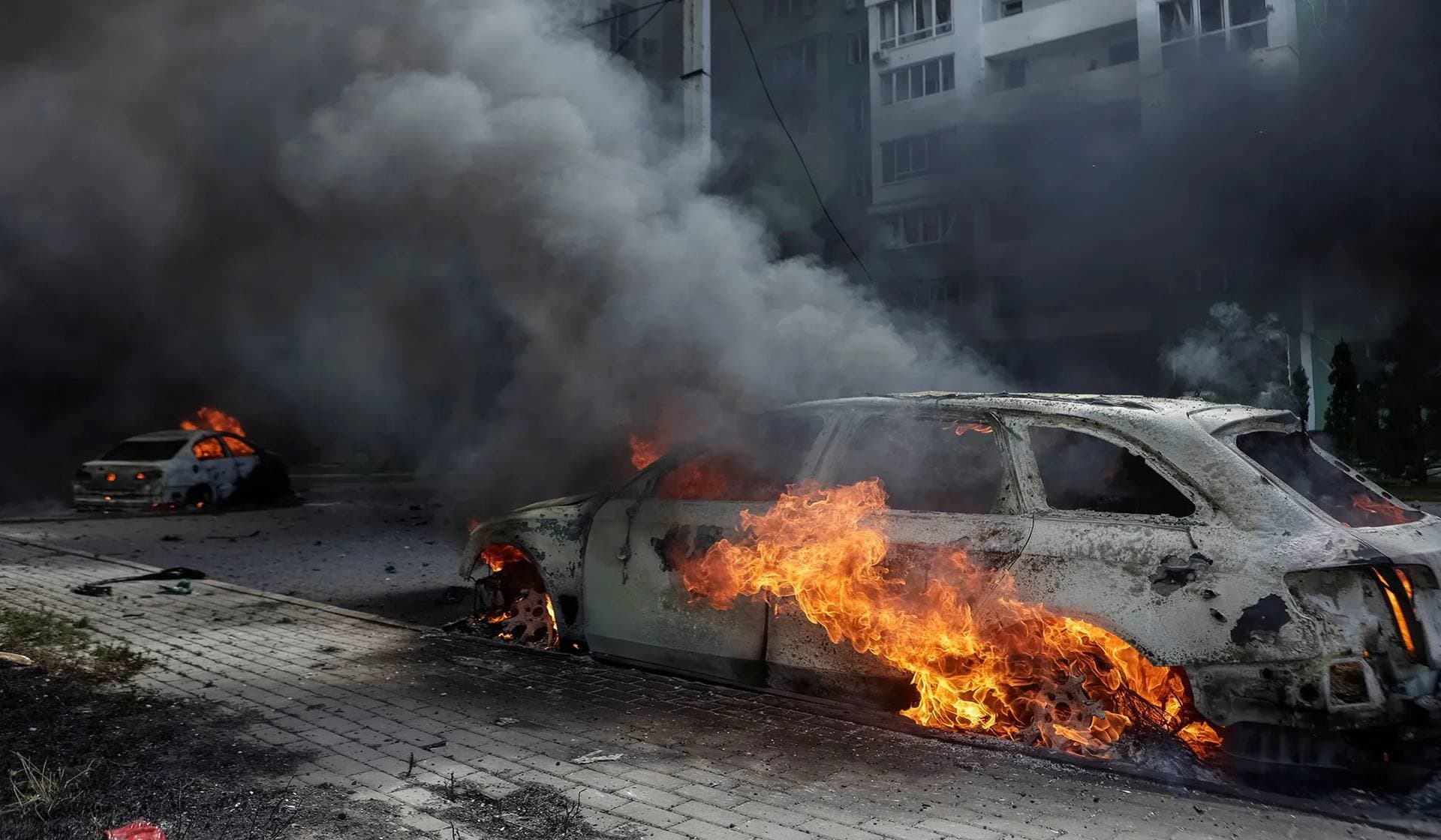Burning cars at the site of a Russian air strike in Kharkiv