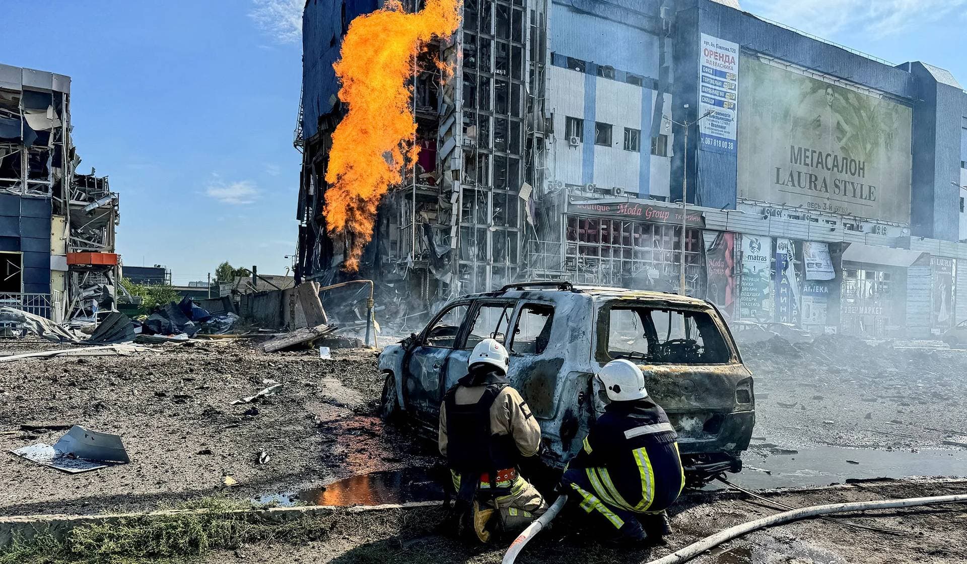 Firefighters work at a site of a Russian missile strike in Kharkiv