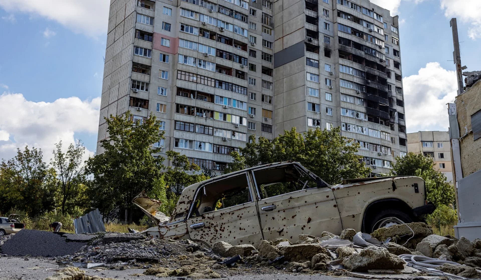 Destroyed buildings and a car in the Saltivka neighbourhood of Kharkiv