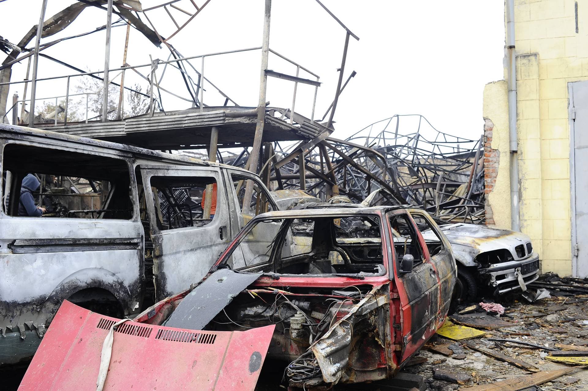 Destroyed cars stand under the rubble of a building after a Russian drone attack in Kharkiv