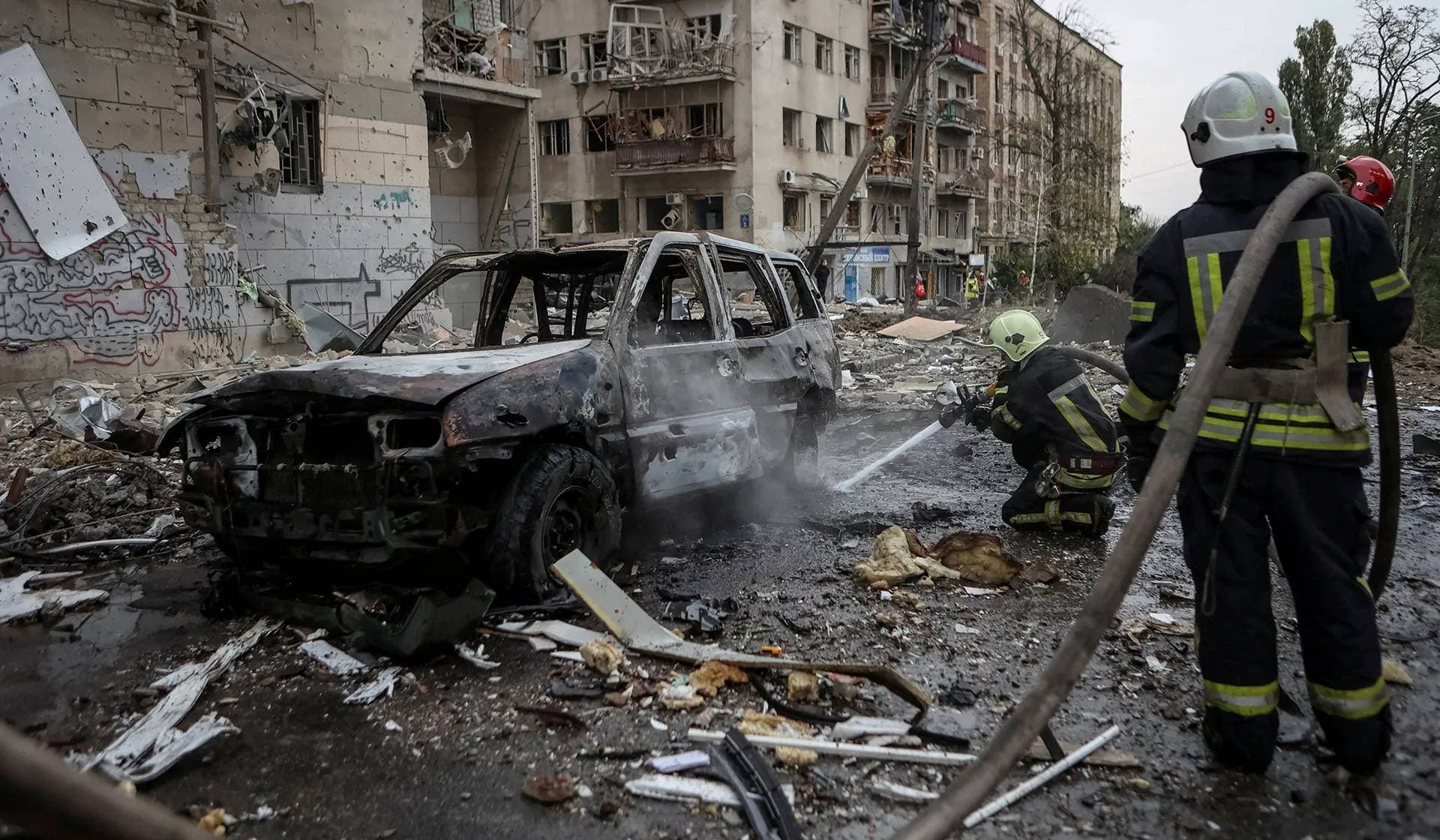 Firefighters work at a site of a Russian missile strike in Kharkiv