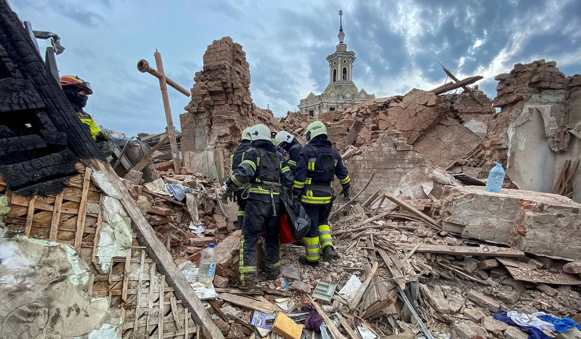 Rescuers carry a bag with the body of 10-year-old boy Tymofii released from debris in Kharkiv