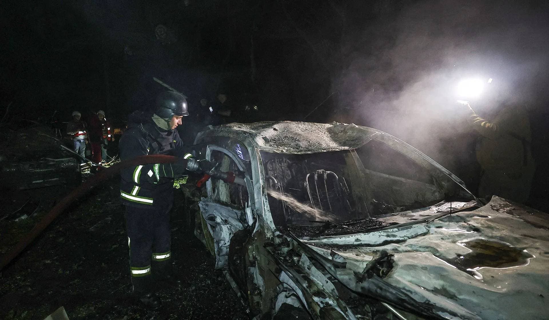 A firefighter works at a site of residential area hit by a Russian air strike in Kharkiv