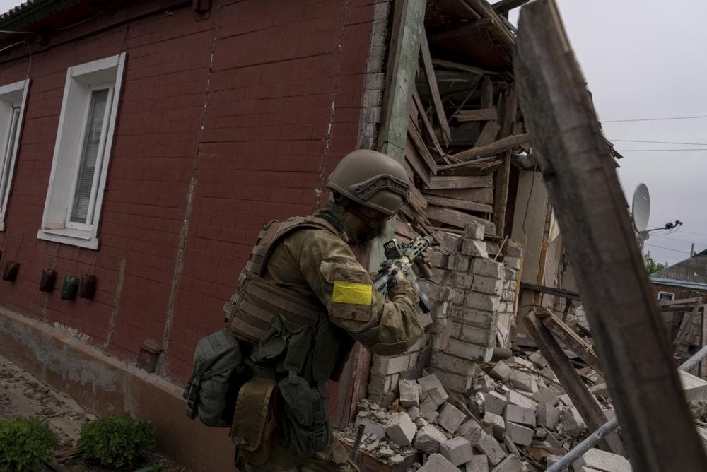 A Ukrainian serviceman patrols during a reconnaissance mission in a recently retaken village on the outskirts of Kharkiv