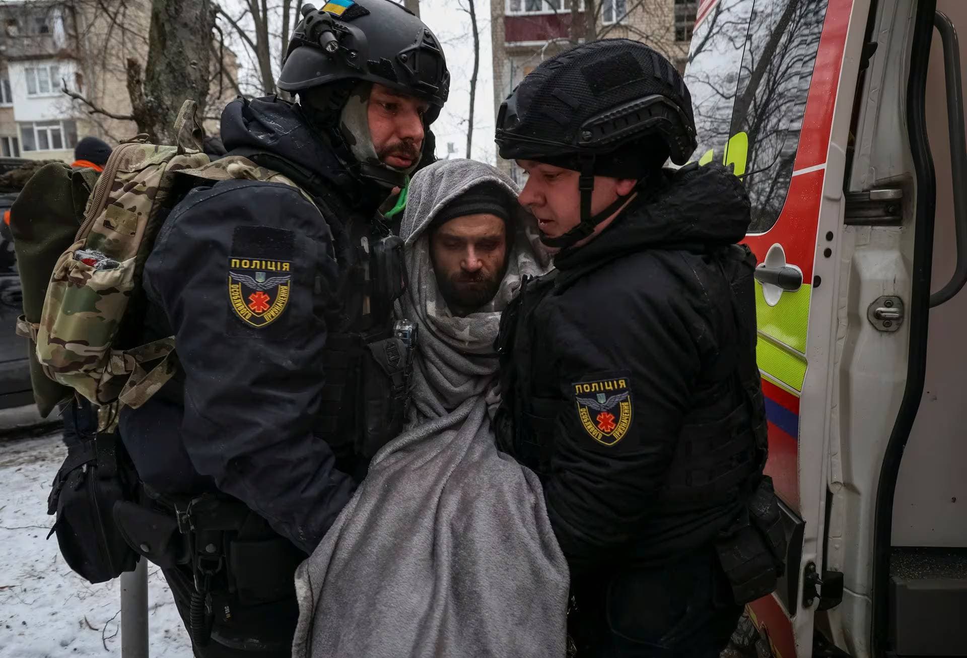Police evacuate a resident from a residential building heavily damaged during a Russian missile attack in Kharkiv