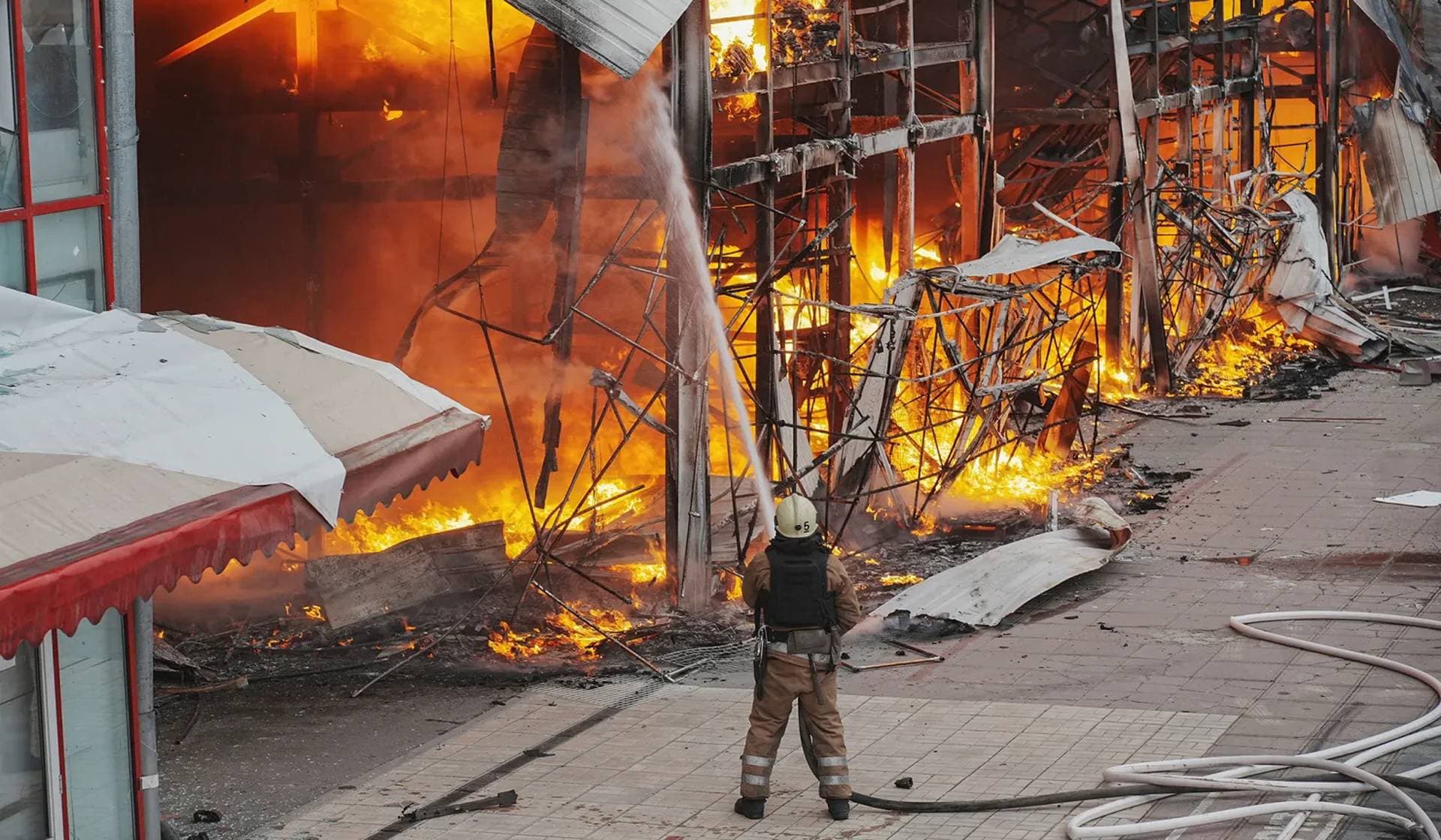 A firefighter works at the site of the Barabashovo market hit by Russian drone strike in Kharkiv