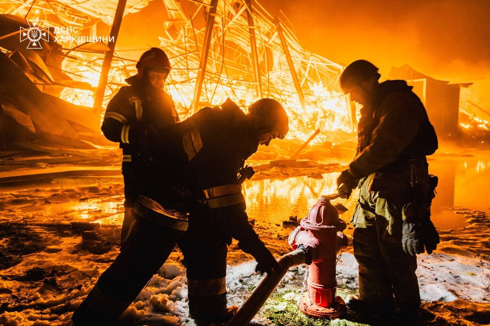 Firefighters work at the site of a private enterprise hit by an overnight Russian missile strike in Kharkiv