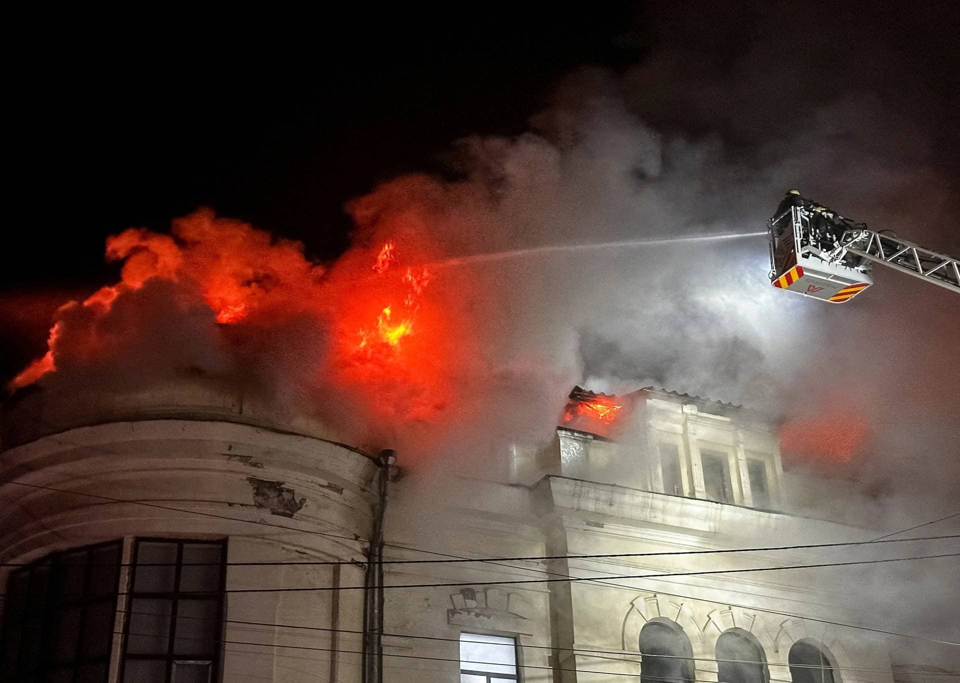 Firefighters work at a site of a Russian drone strike in Kharkiv