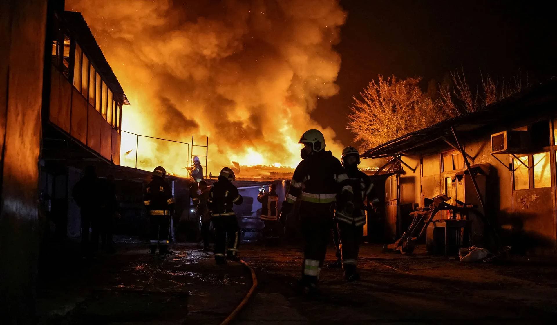 Emergency personnel work at a site of a Russian drone strike in Kharkiv