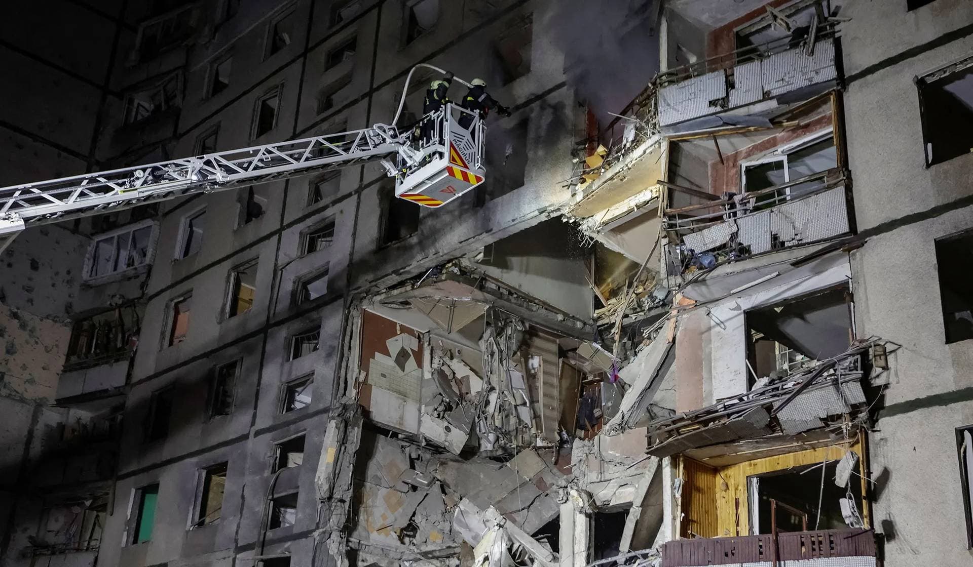 Rescuers work at the site of an apartment building hit by a Russian air strike in Kharkiv