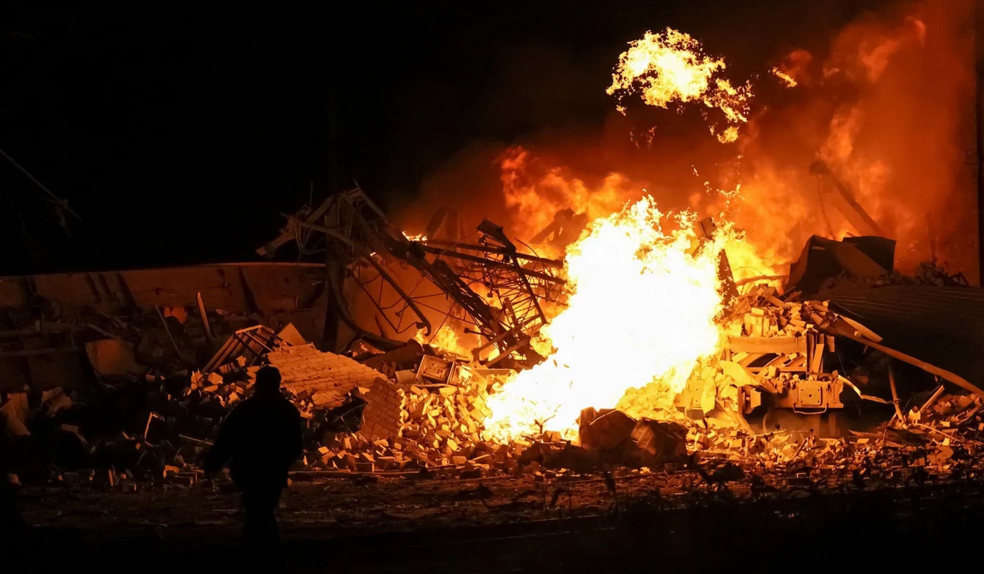 A fire at the site of a Russian missile strike in Kharkiv