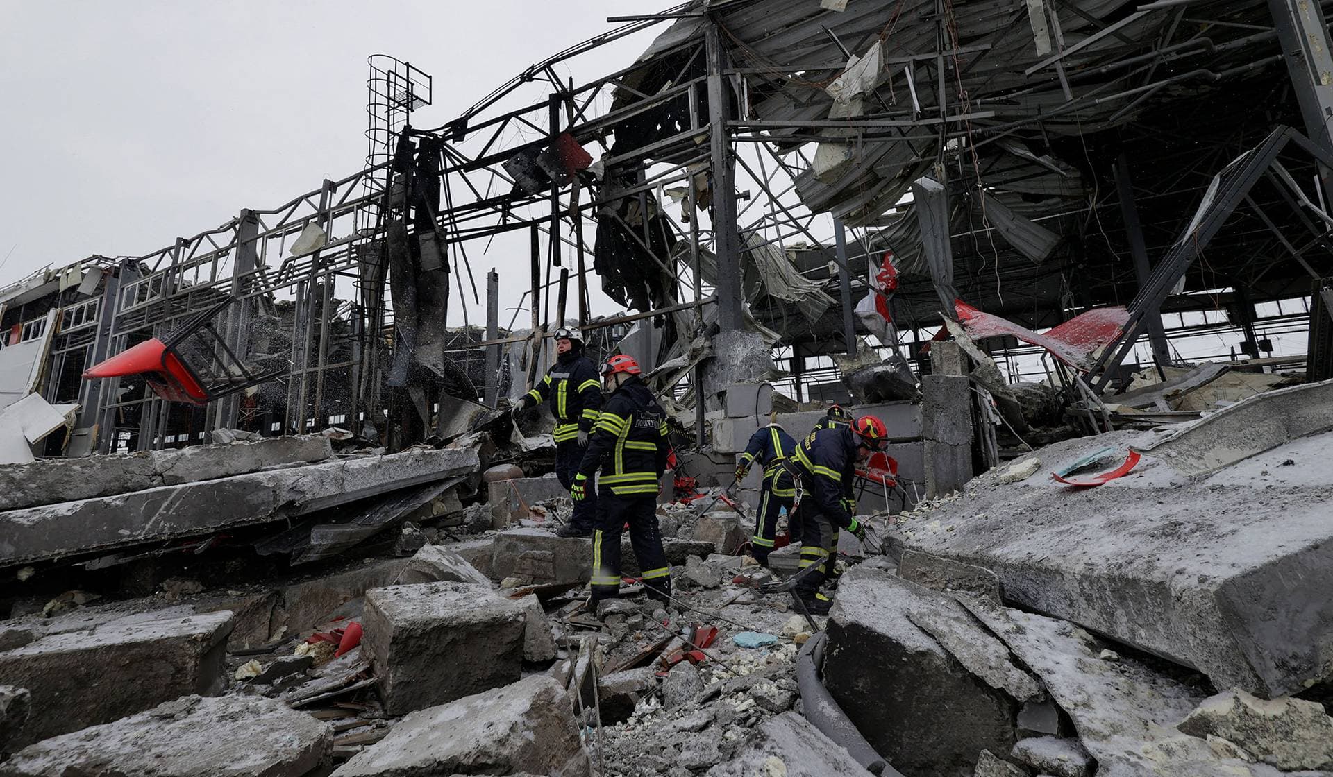 Rescuers work at the site of a logistics hub of a private delivery company hit by Russian missile strikes in Kharkiv