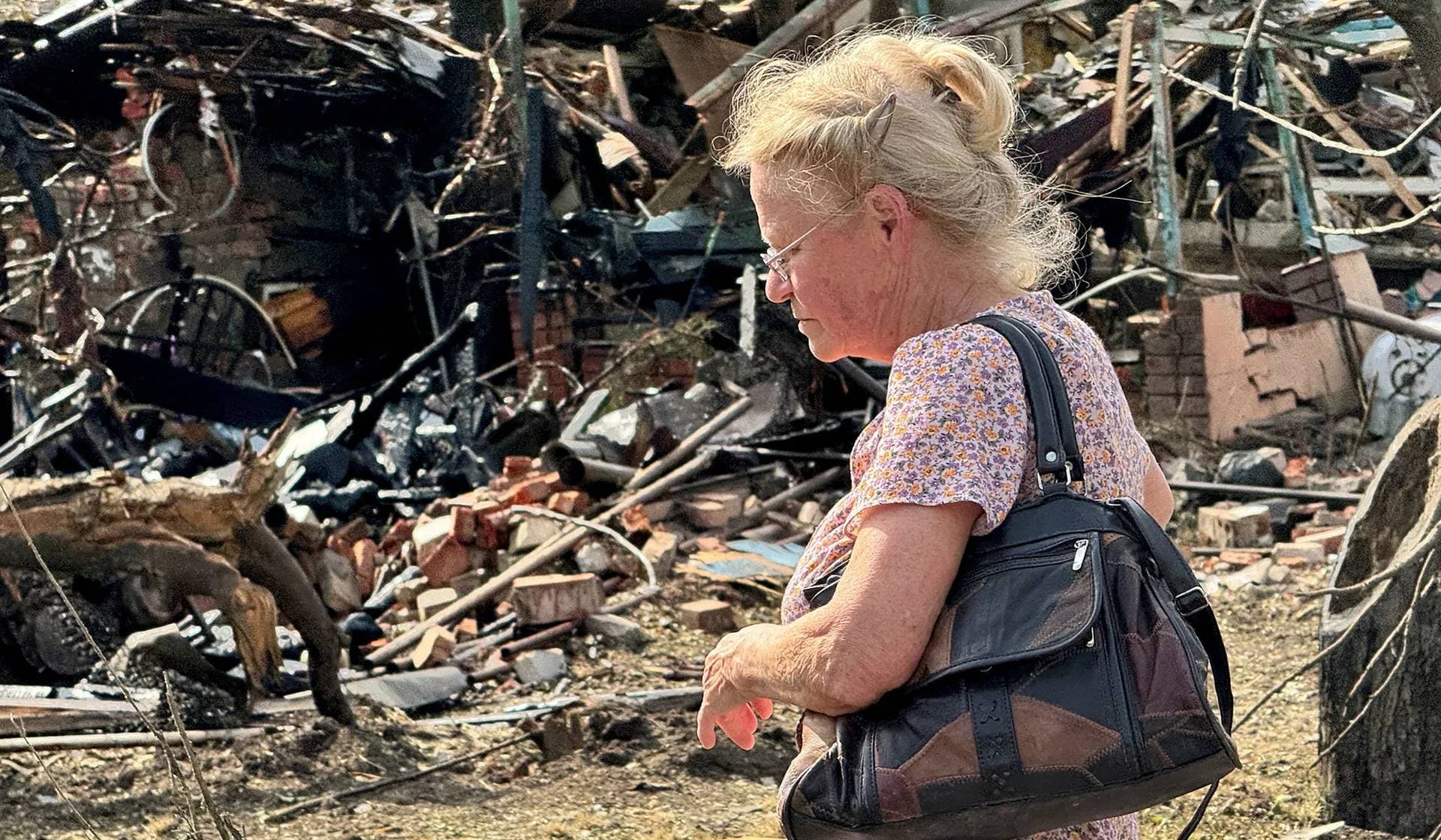A local resident stands at the site of a Russian air strike in Kharkiv