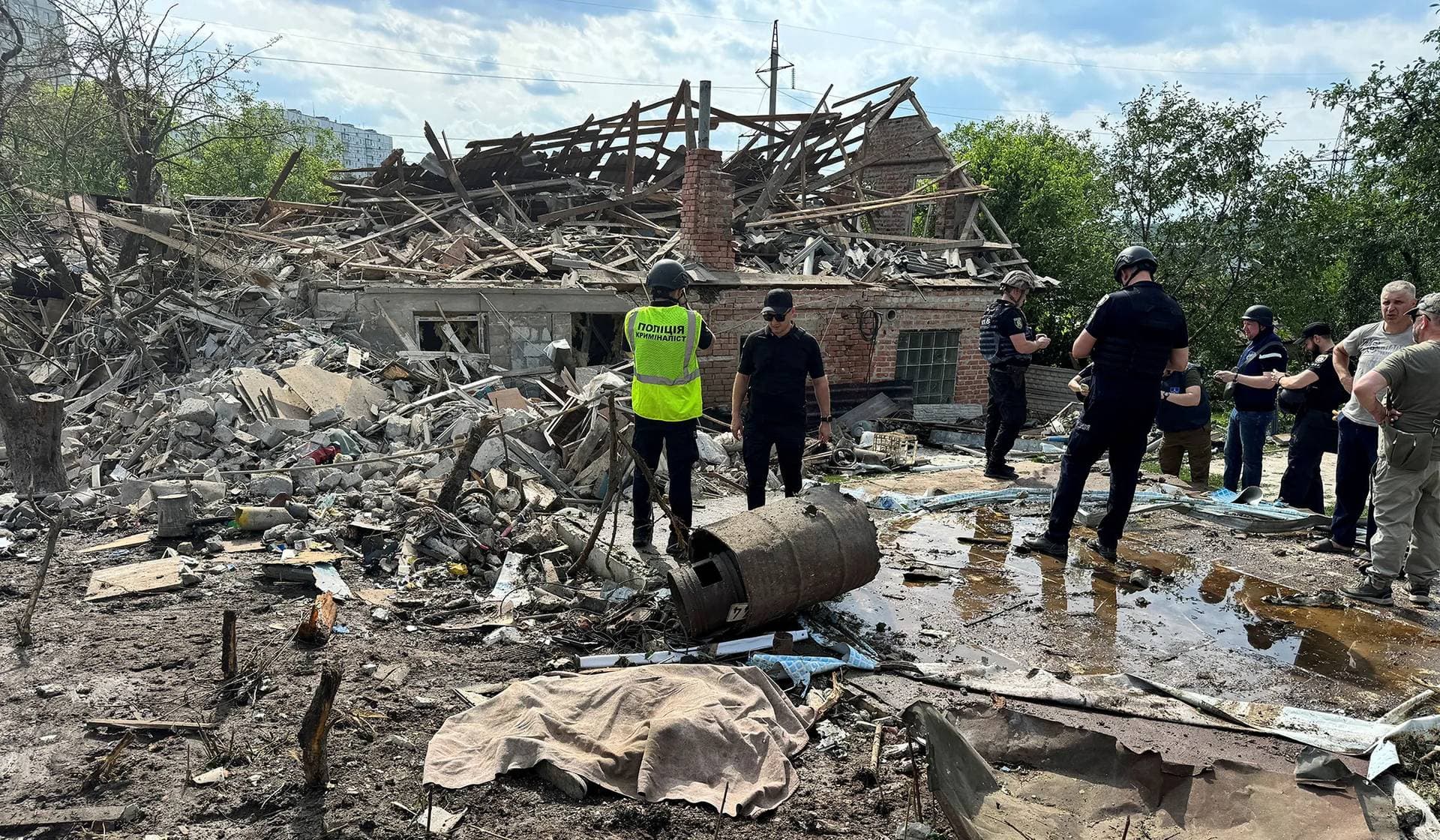Police officers work at a site of a Russian air strike in Kharkiv