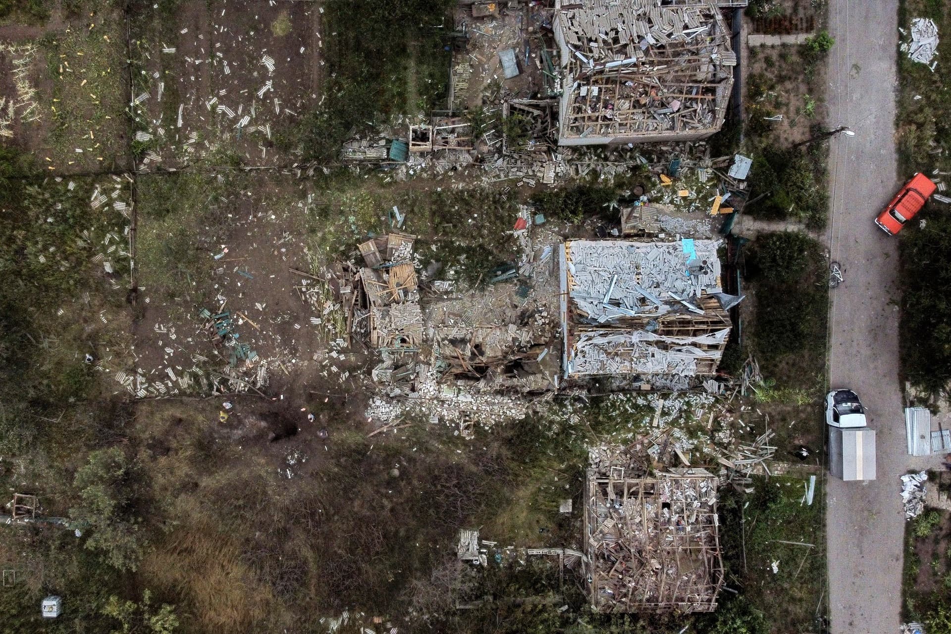 A crater from a Russian rocket attack Friday night is seen next to damaged homes in Kramatorsk