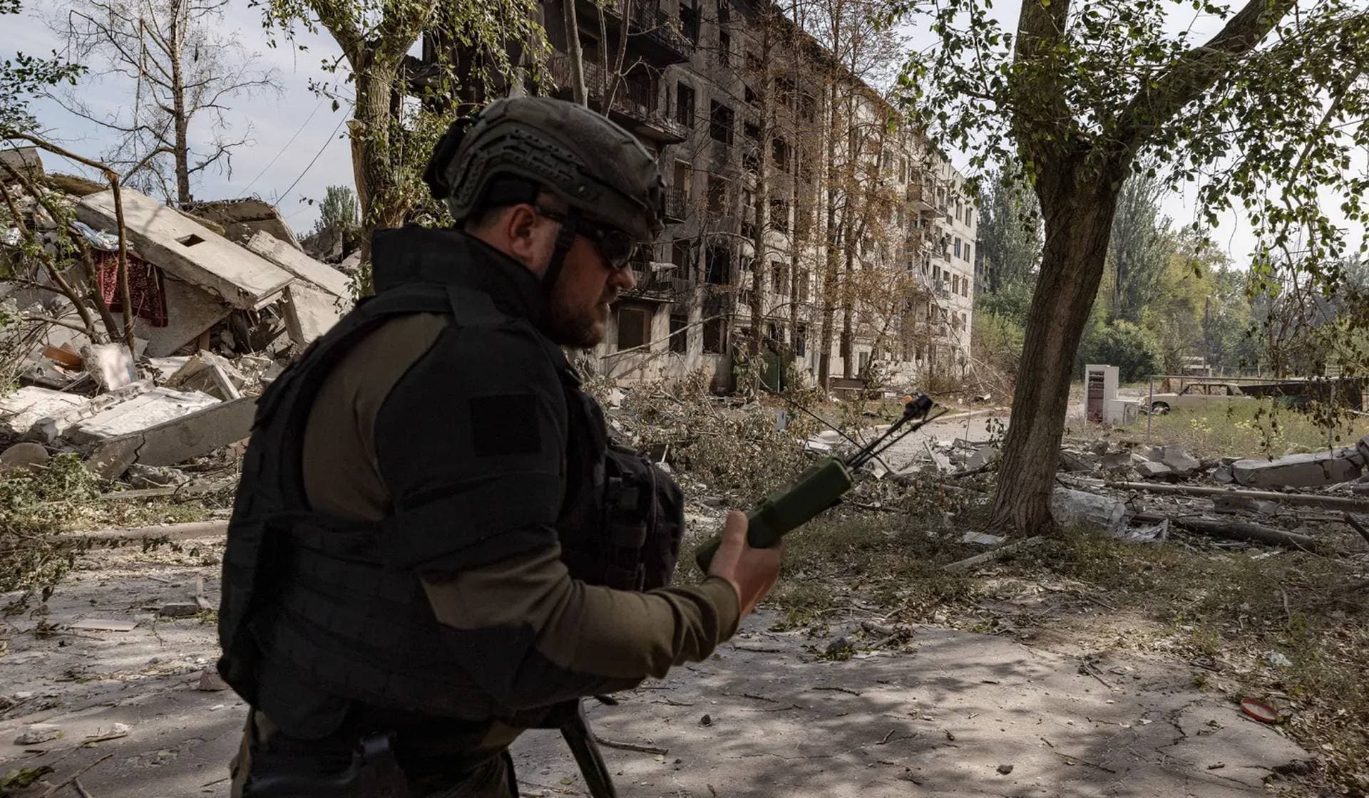 A member of the White Angels police evacuation unit uses a drone detector during an evacuation of residents from the frontline town of Kostiantynivka