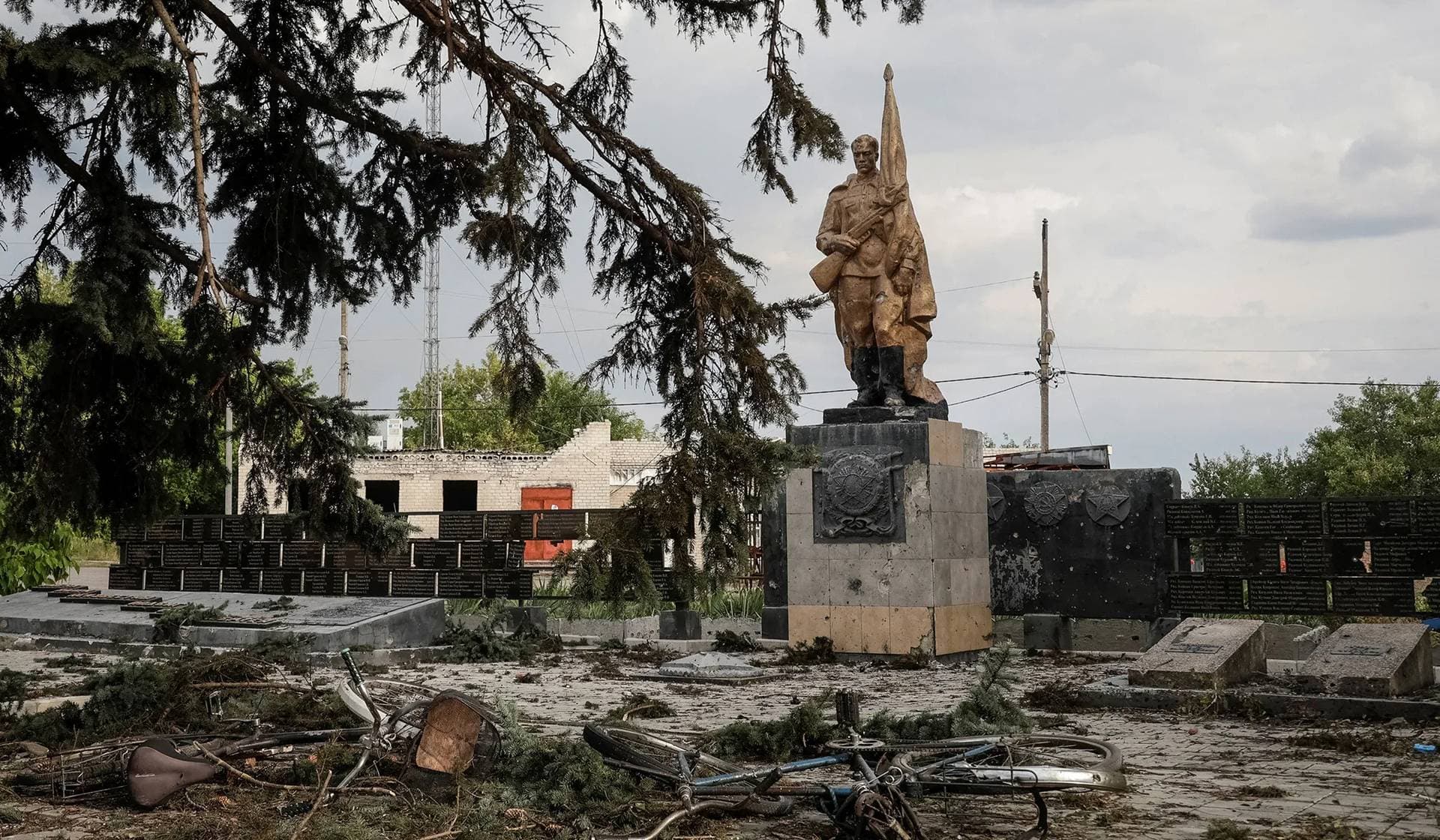 A damaged bicycle and debris lie on the ground following a Russian air strike that killed several civilians at a pension disbursal point in Yarova
