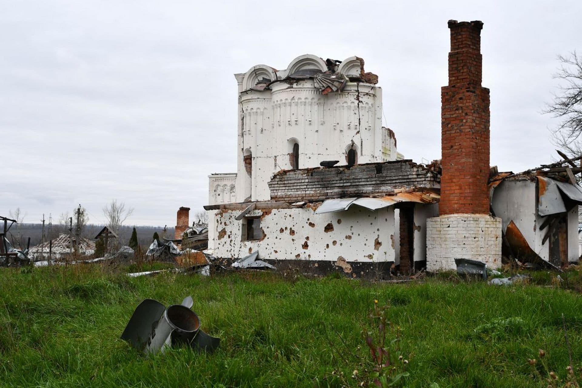The tail of a missile sticks out in a yard of the St. George's Skete in the village of Dolyna