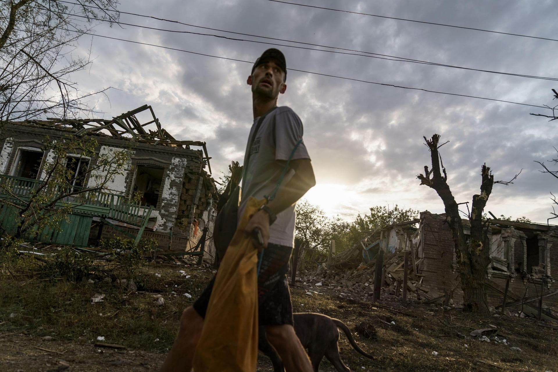 A person walks past the damaged homes from a rocket attack early this morning in Kramatorsk