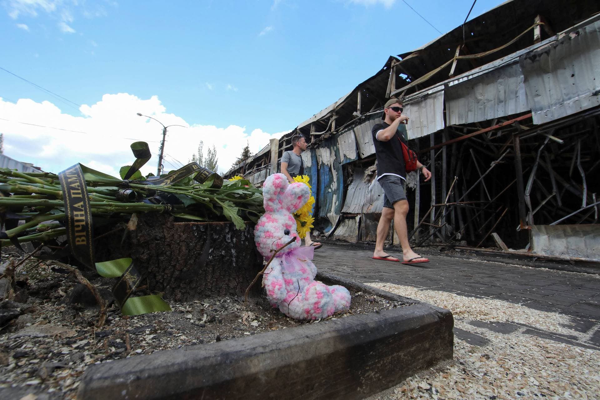 Flowers left by local residents to pay tribute to civilian people killed yesterday are seen at the strike site in Kostiantynivka