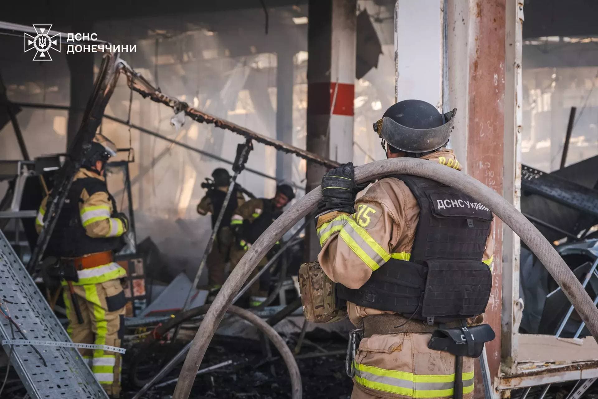 Firefighters work inside a supermarket heavily damaged by a Russian military strike in Kostiantynivka