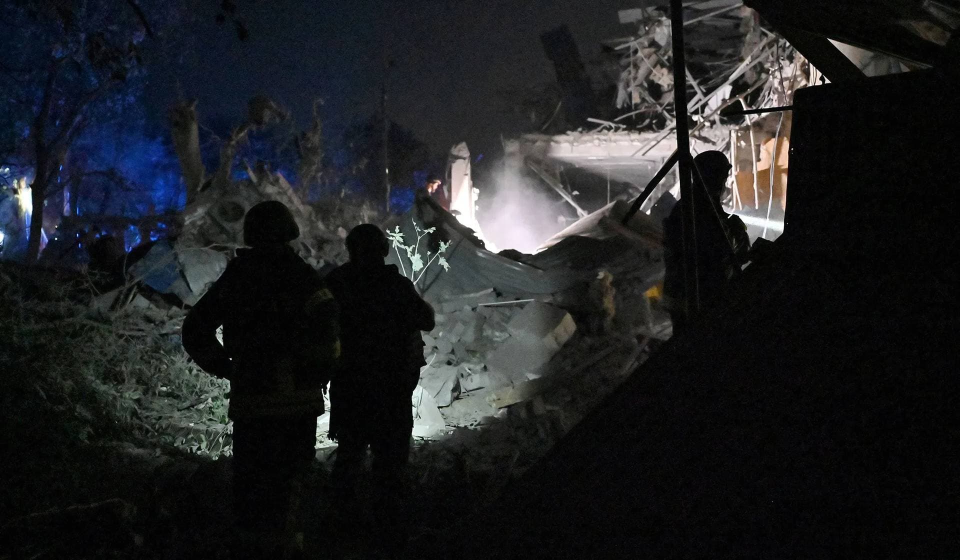Ukrainian emergency services conduct a search-and-rescue operation among the rubble at the site where a hotel was hit by a missile in Kramatorsk