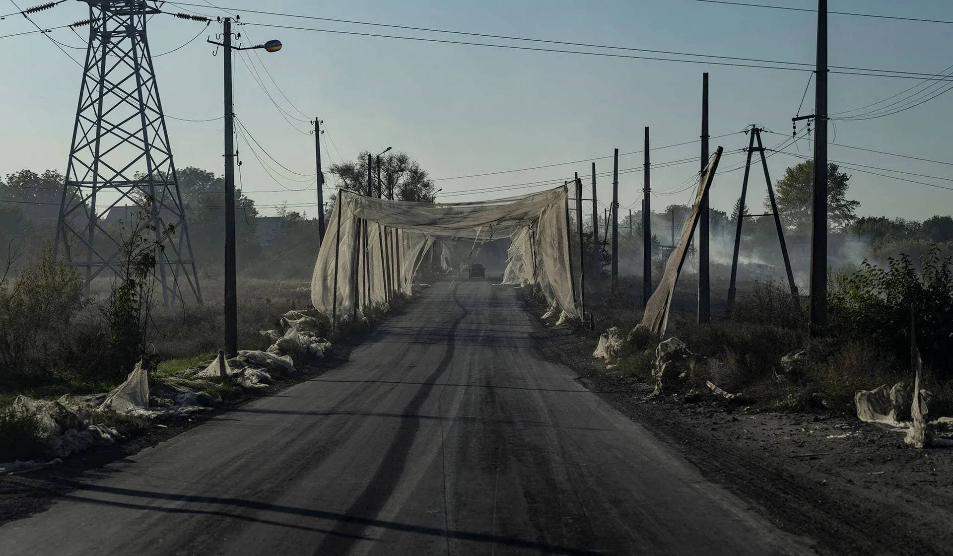 A car drives along a street covered with an anti-drone net in the frontline town of Kostiantynivka