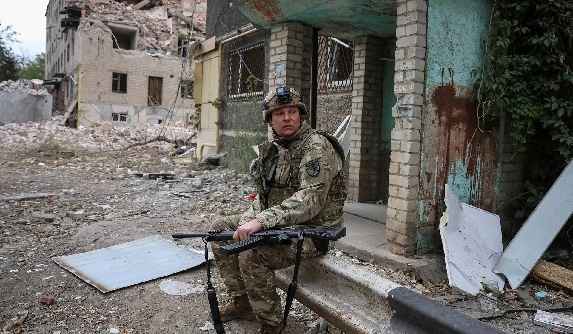A Ukrainian serviceman holds a shotgun as he looks out for Russian combat drones in the frontline town of Kostiantynivka