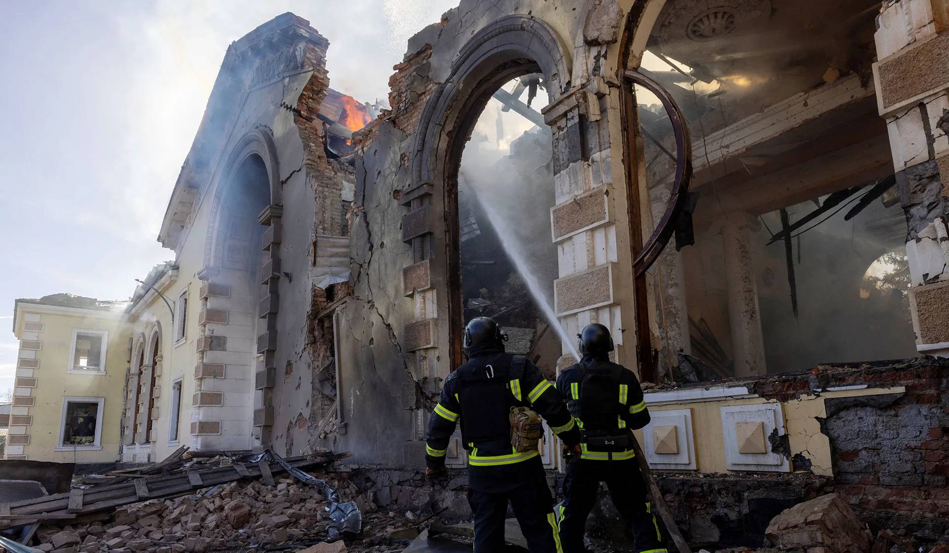 Firefighters work at the scene of a Russian missile strike that destroyed a train station in Kostyantynivka