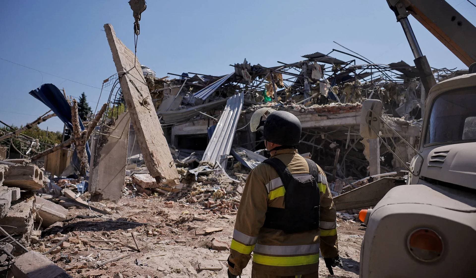 Ukrainian emergency personnel works among the rubble at the site where a hotel was hit by a missile in Kramatorsk