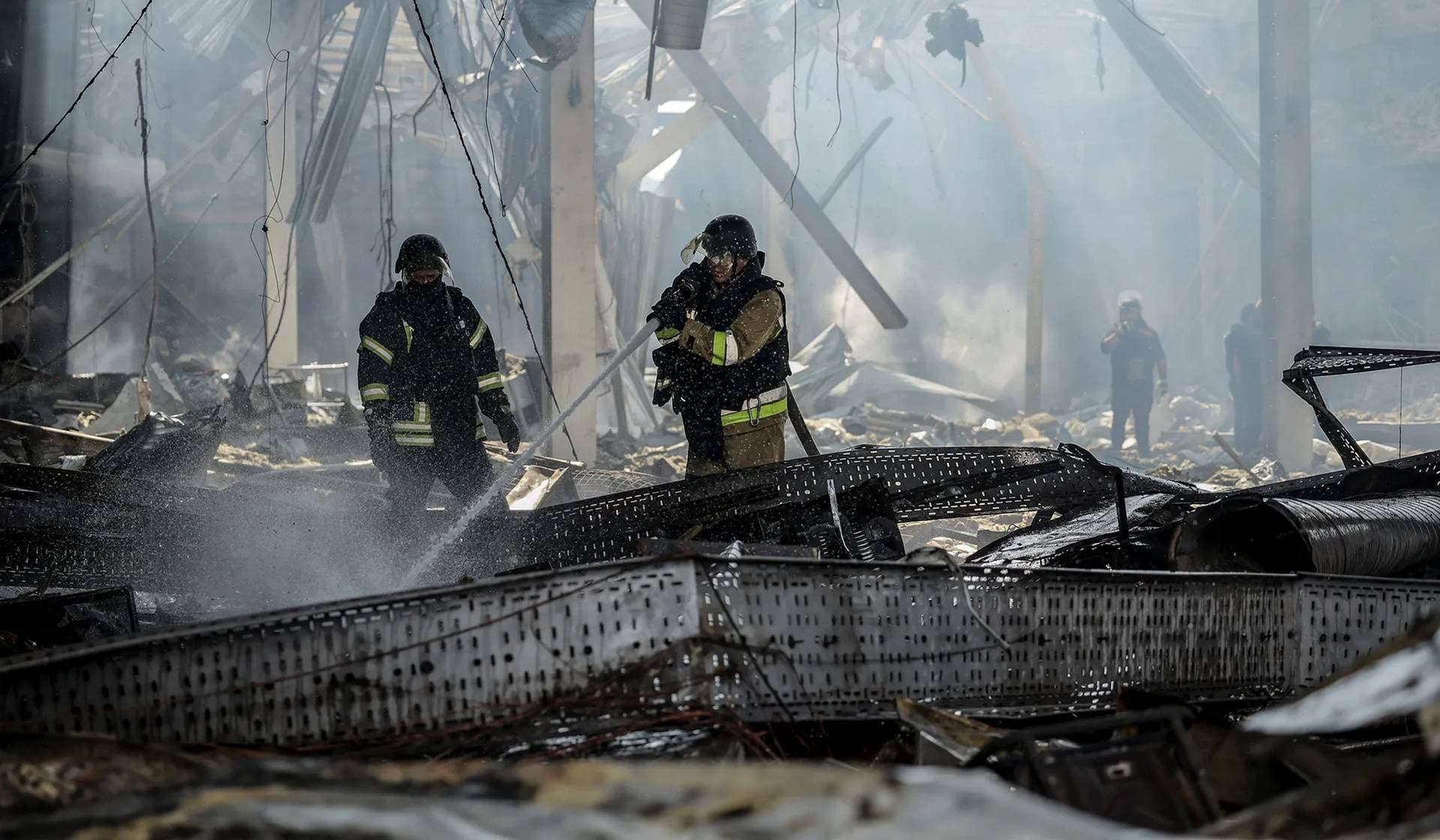 Firefighters work at a site of a supermarket heavily damaged by a Russian military strike in Kostiantynivka