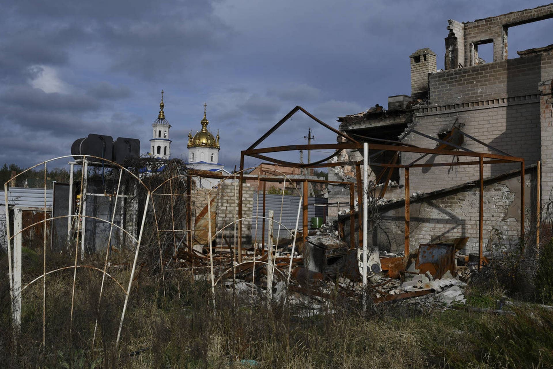 A view of buildings damaged by shelling with an Orthodox Church in village of Shchurove