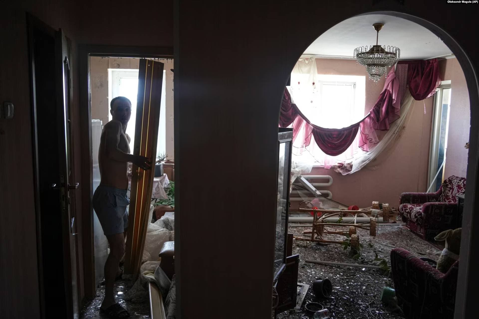A man begins the task of cleaning up his apartment