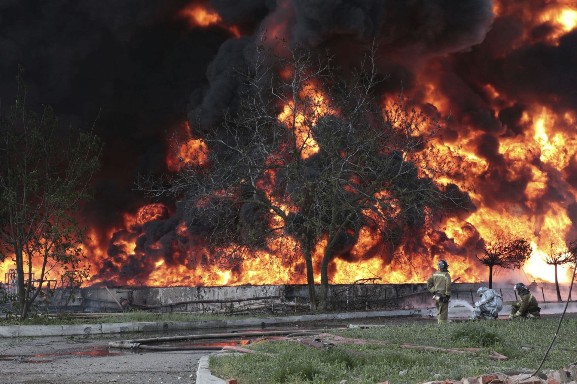 firefighters work at the site of fire at the oil depot after missiles struck the facility in Makiivka
