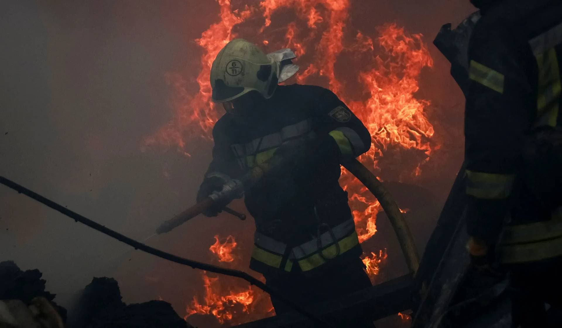 Firefighters work at the site of a Russian drone strike in the outskirts of Odesa