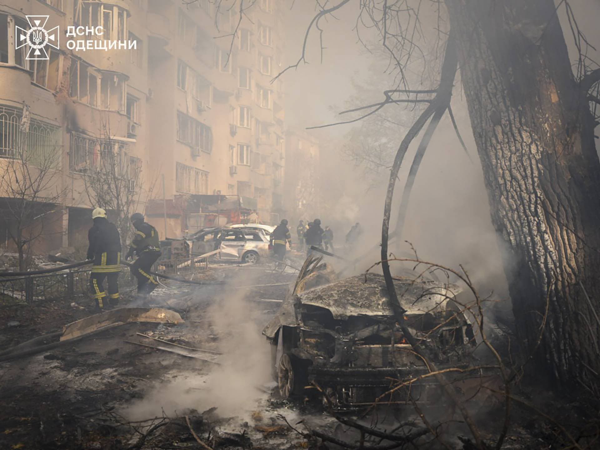 Firefighters work at the site where a residential area was hit by a Russian missile strike in Odesa