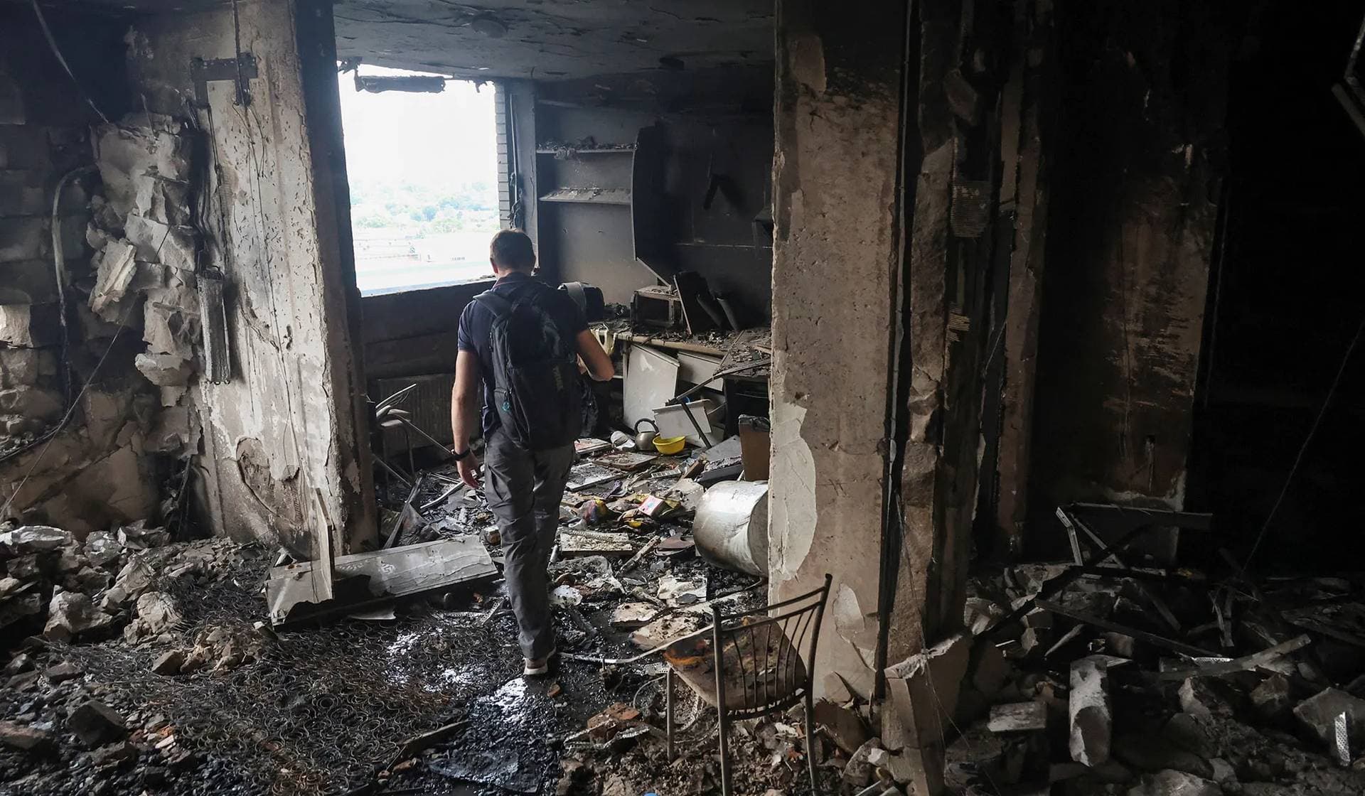 A resident walks inside his apartment building hit by a Russian drone strike in Odesa