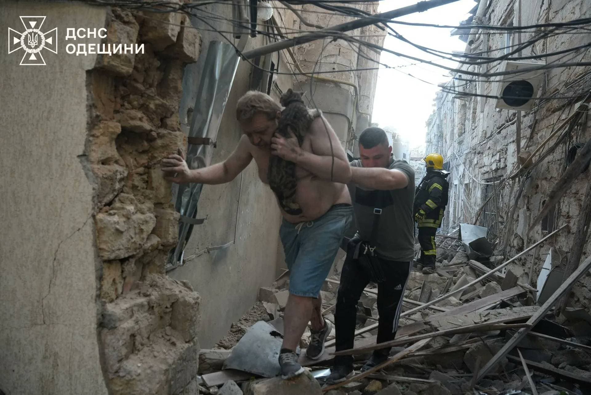 Residents leave the site of a Russian drone strike in Odesa