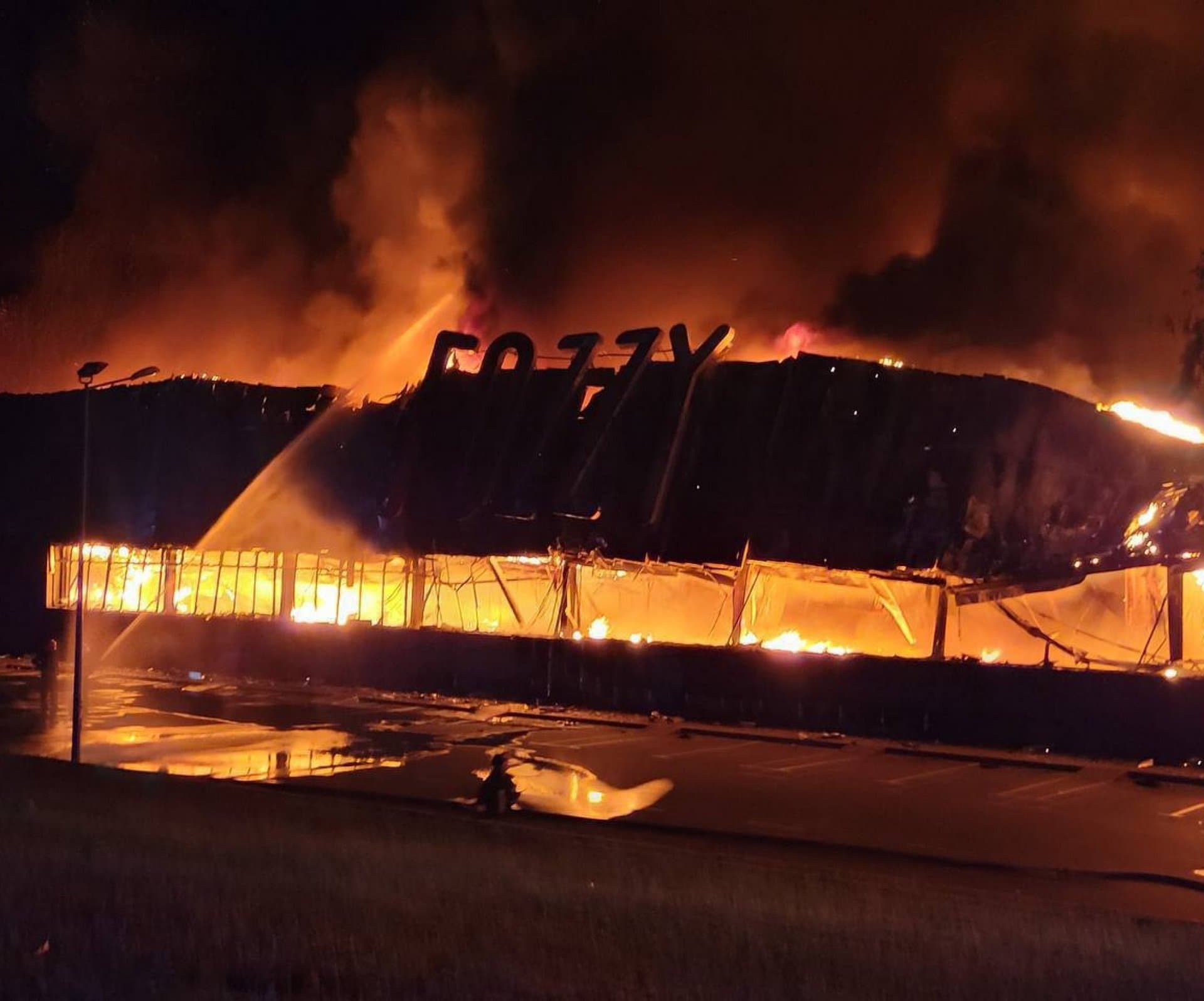 Firefighters work to put out a blaze at a supermarket following Russian strikes on Odesa