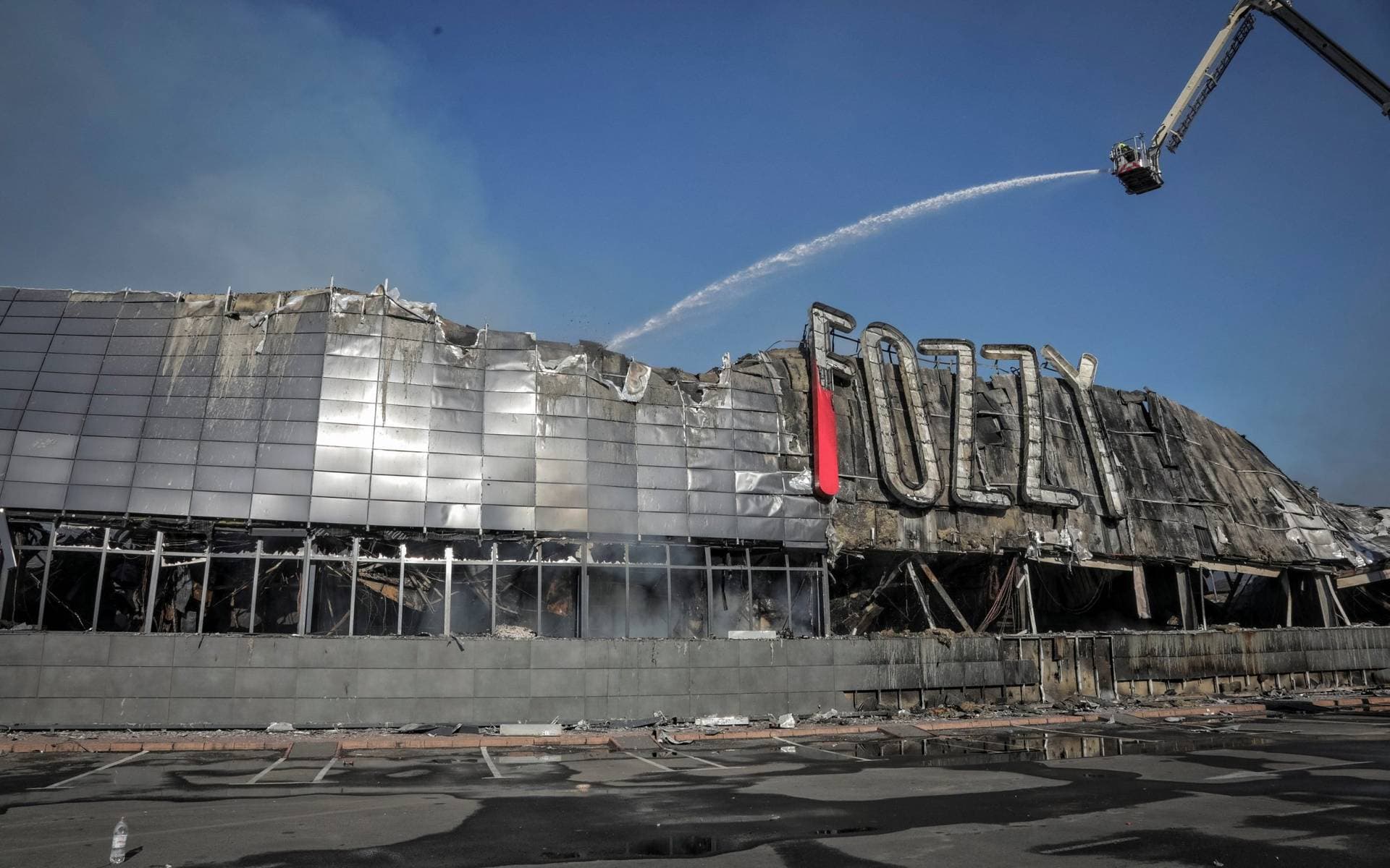 Rescuers work at a site of a shopping mall destroyed during a Russian military strike, amid Russia's attack in Odesa