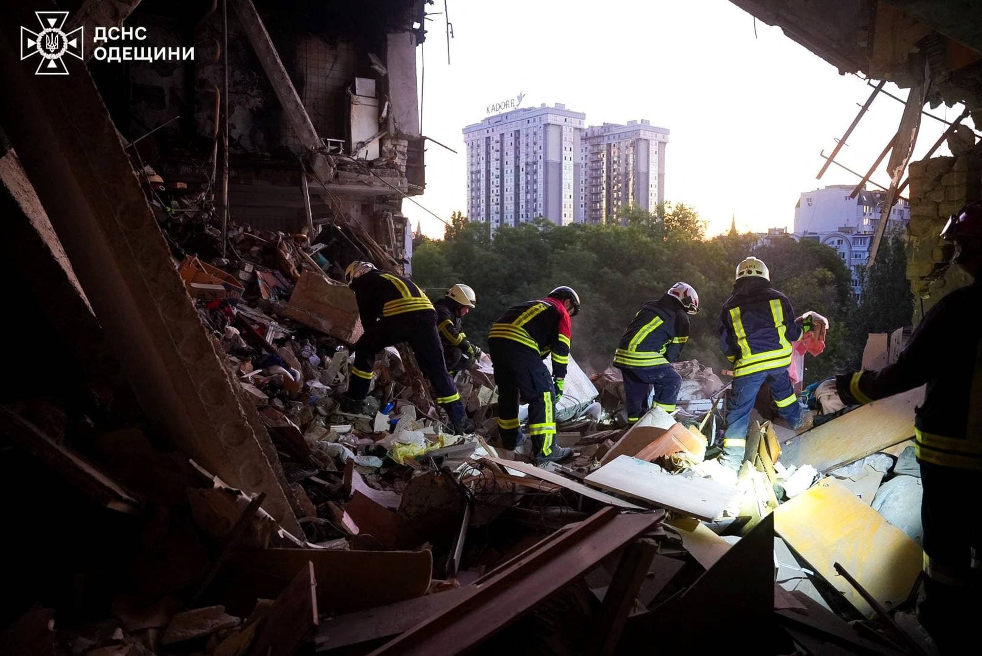 Firefighters work at the site of an apartment building damaged during a Russian drone strike in Odesa