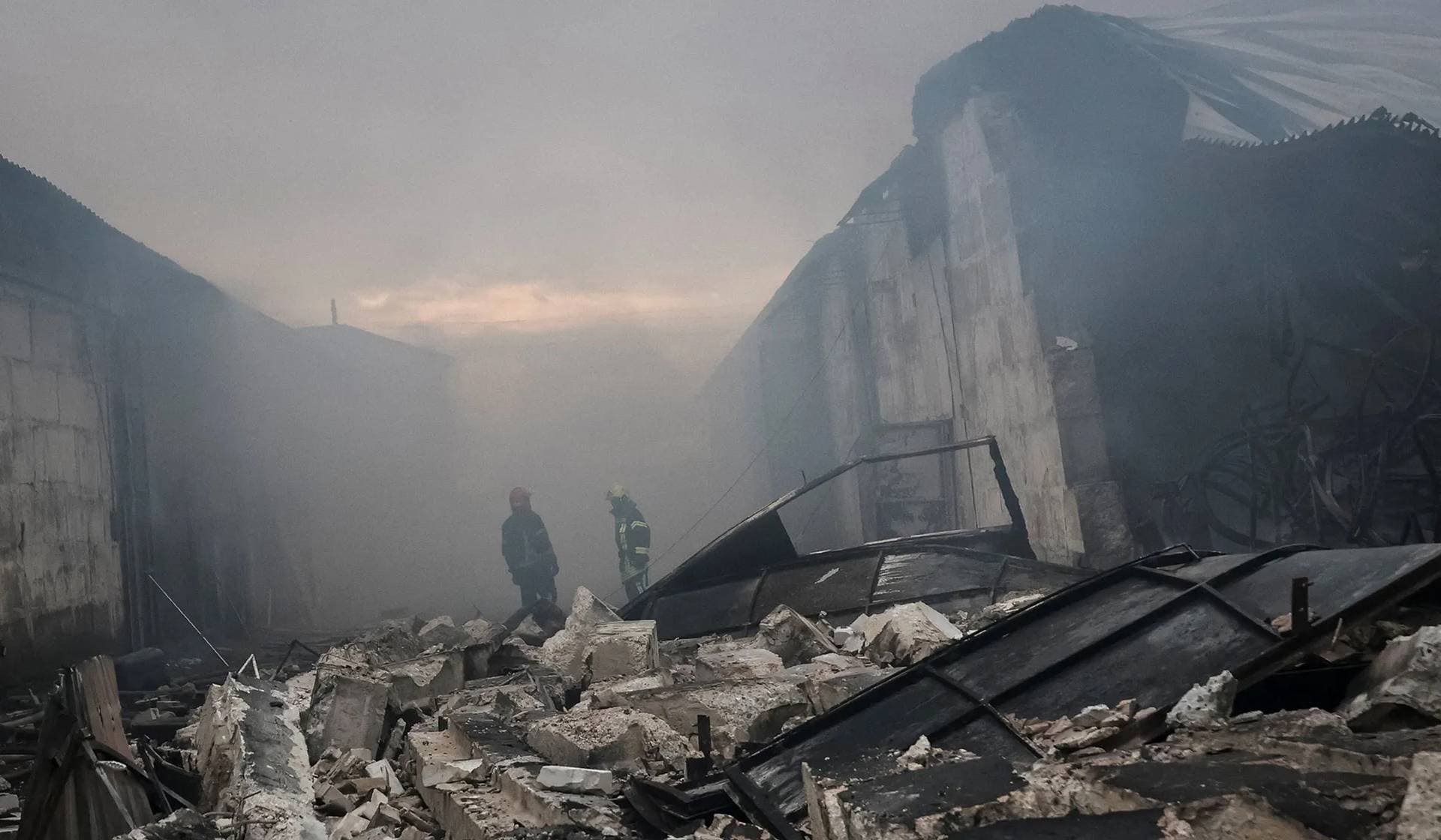 Firefighters work at the site of a Russian drone strike in the outskirts of Odesa