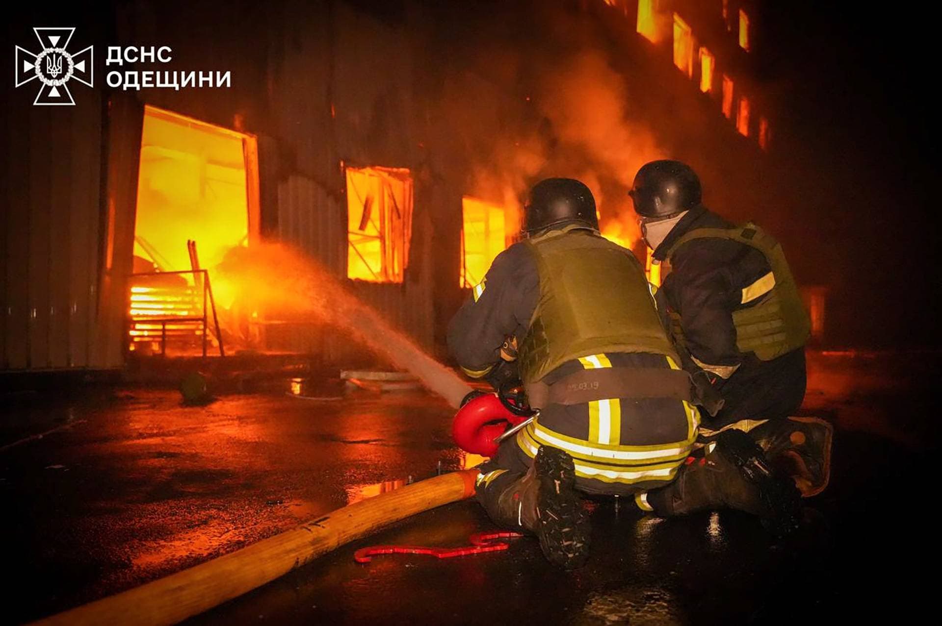 Firefighters work at the site of a Russian missile strike at a location given as Odesa