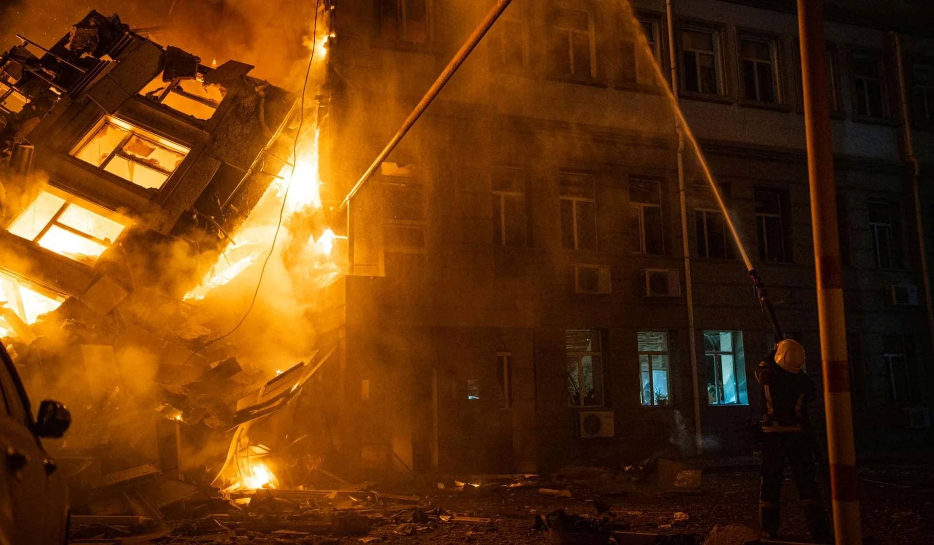 A firefighter works at a site of an administrative building heavily damaged by a Russian missile strike in Odesa