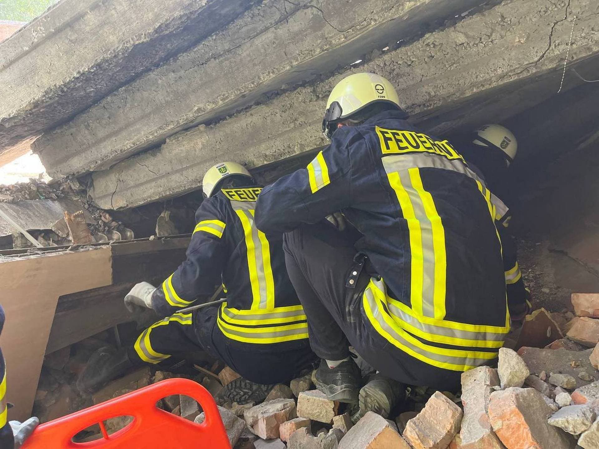 Rescuers work at the site of a Russian drone strike in Romny