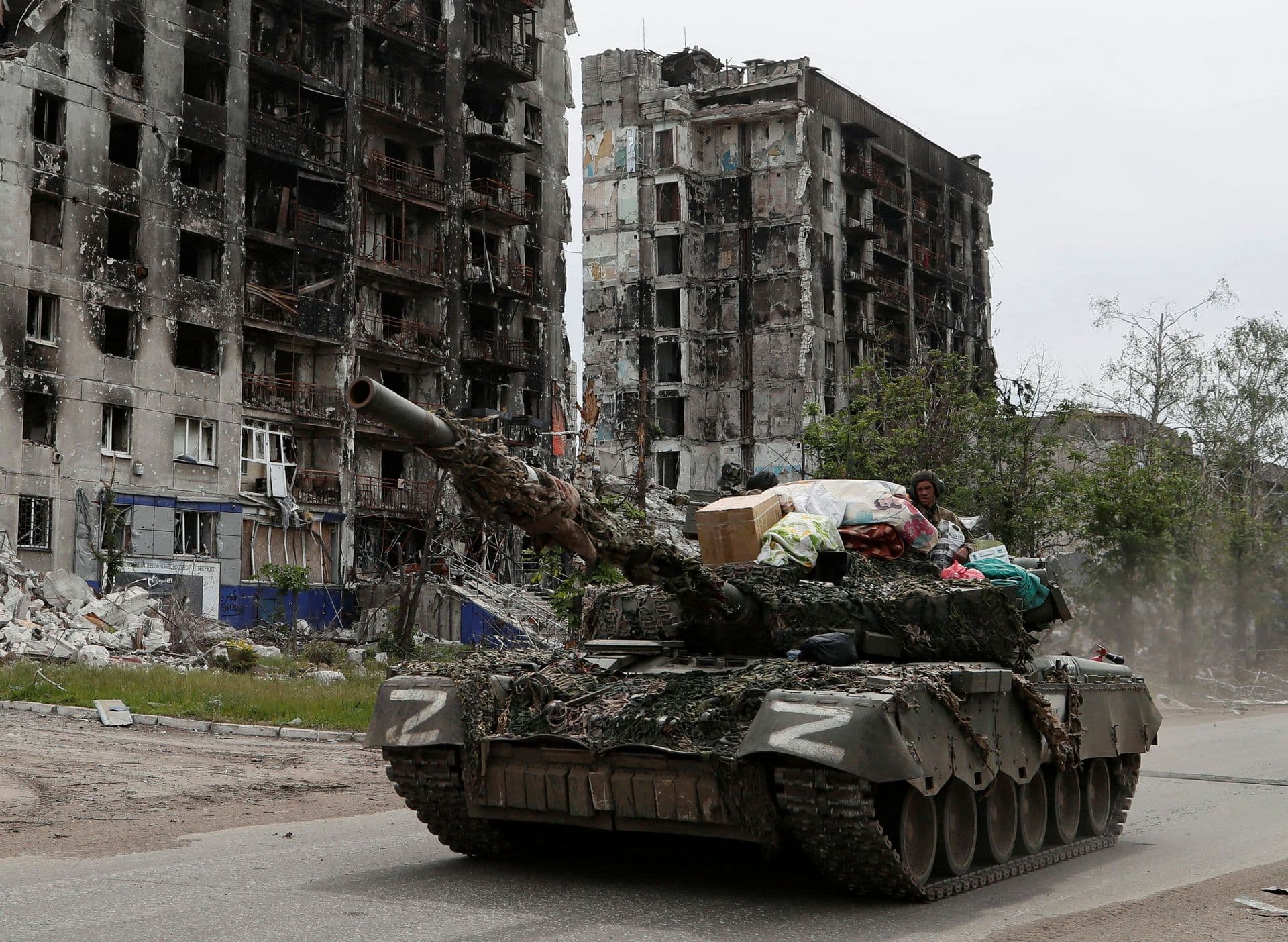 A tank manned by Russia-backed separatists drives through the streets of Popasna in May 2022.