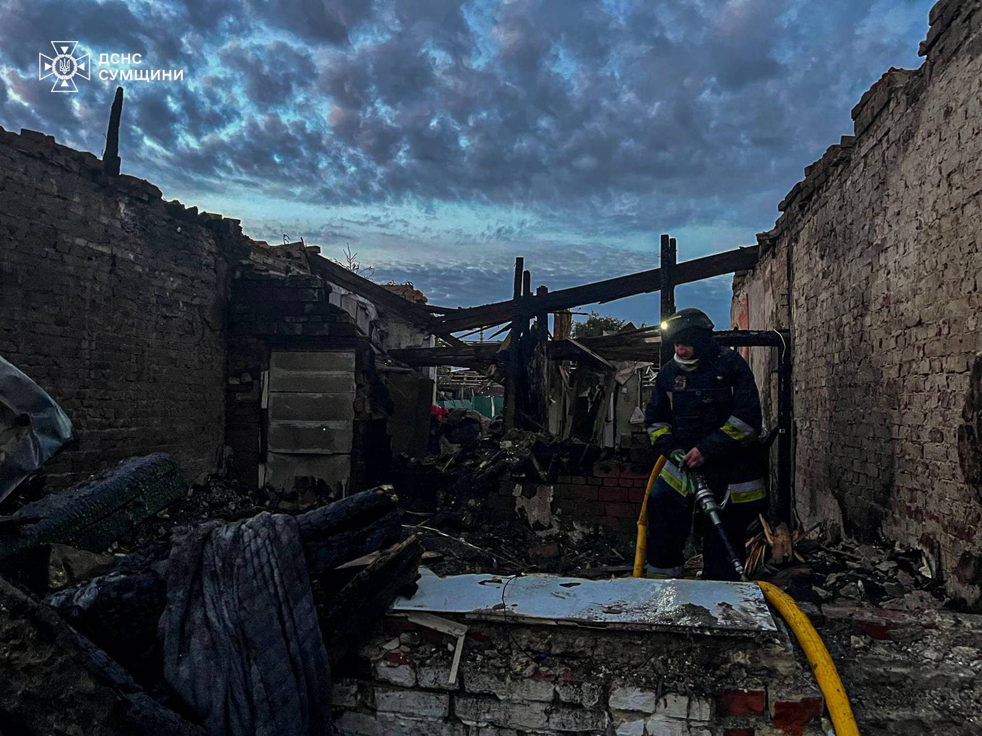 A firefighter works at the site of a Russian drone strike in Sumy Region
